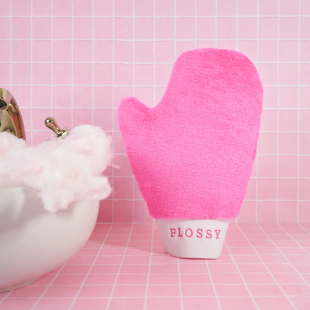 Flossy Tools Microfibre Makeup Removing Mitt, Fluffy Glove, glove that will remove your makeup with just water. In pink tiled bathroom with candy floss in the sink.